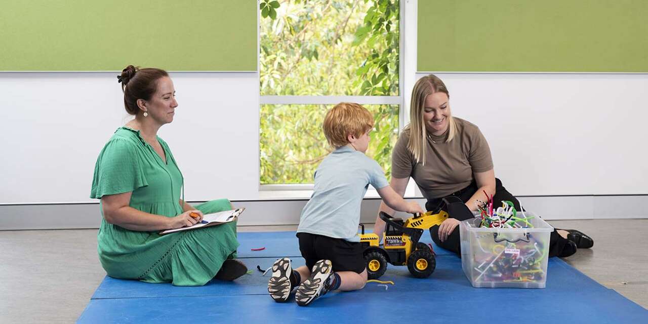 Student in a clinical setting with a parent and child