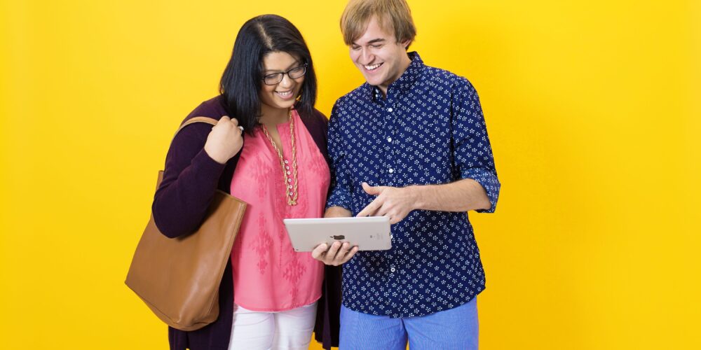 Two students reporting an incident using an iPad.