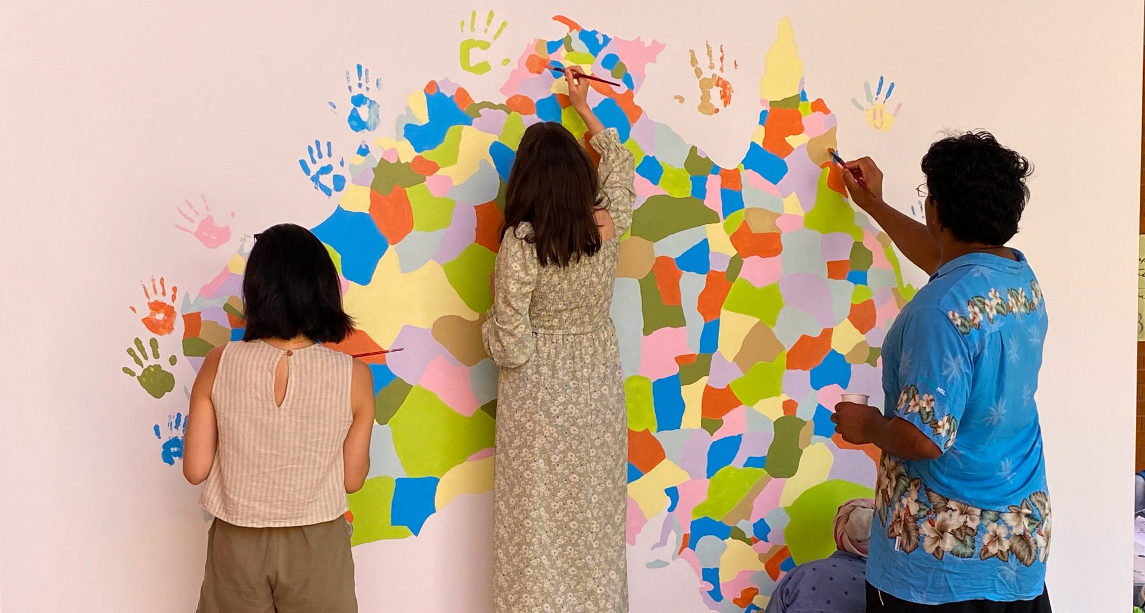 Curtin Students with collaborative mural Terra Nullius by Tony Albert as part of ProppaNow component of the exhibition However vast the darkness…Photo by Catherine Peattie.