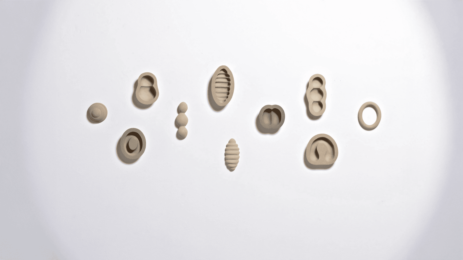 Angela Valamanesh, Outside / Inside #A, 2008, unglazed ceramic, 10 parts, 55 x 155 x 5.5 cm. Purchased with funds donated through Curtin Foundation, 50fifty Acquisition Initiative, 2018. Courtesy of the artist and GAGPROJECTS, Adelaide. Photographer: M Kluvanek