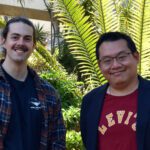 Alexander Hamilton and his supervisor Dr Hendra Gunosewoyo smile at the camera, standing on Curtin campus in front of foliage