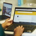 Student searching the catalogue on a laptop