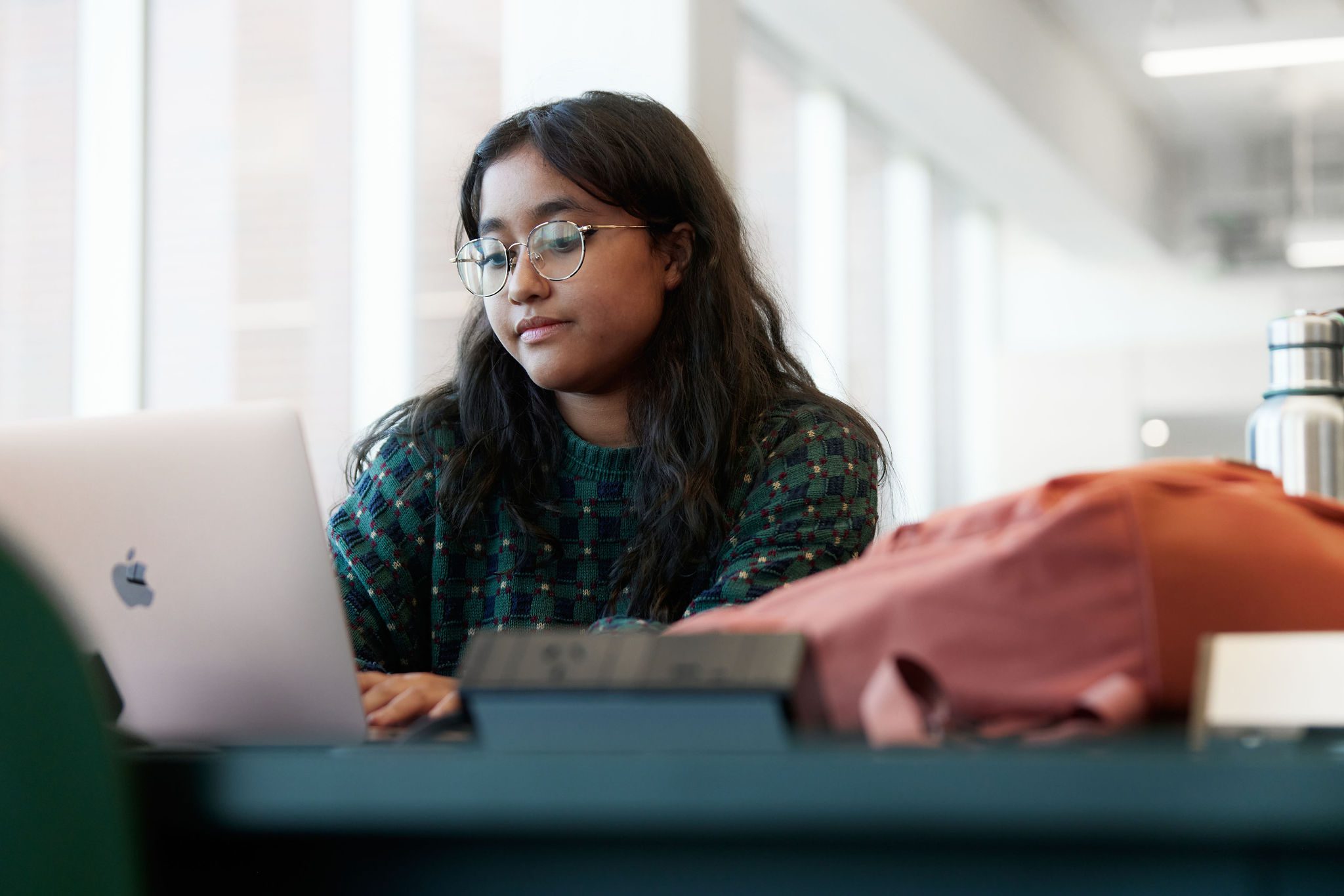 Student writing on a laptop