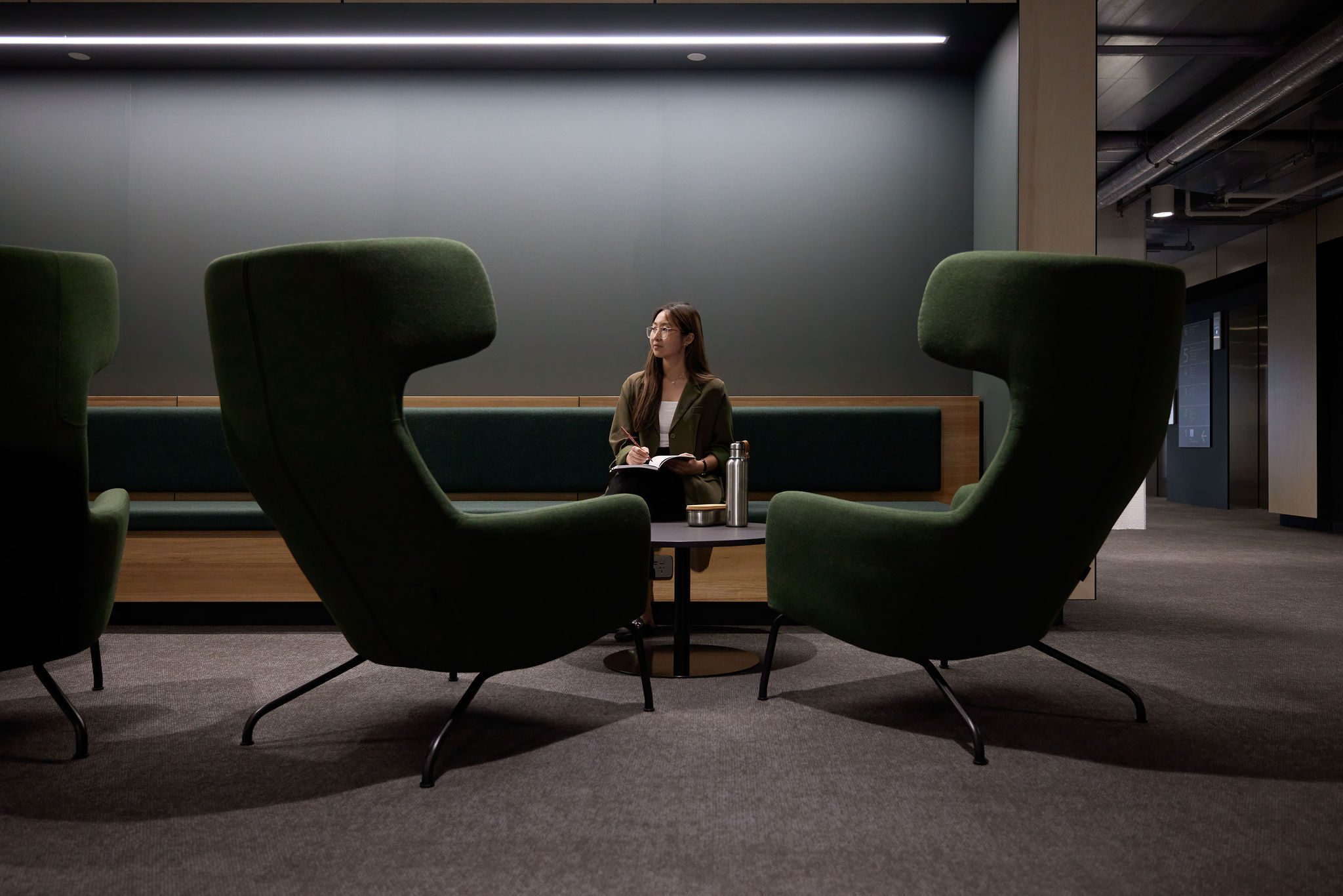 Student sitting on a seat with a water bottle