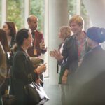 Conference attendees talking in a circle.