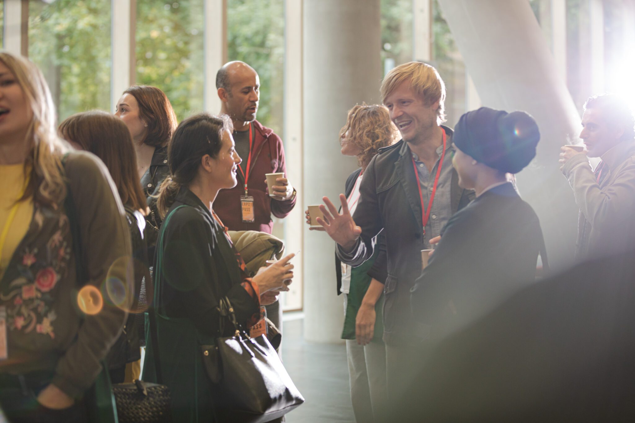 Conference attendees talking in a circle.