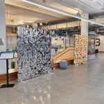 Photo taken in TL Robertson Library. It shows two photo backdrops located near a large set of stairs.