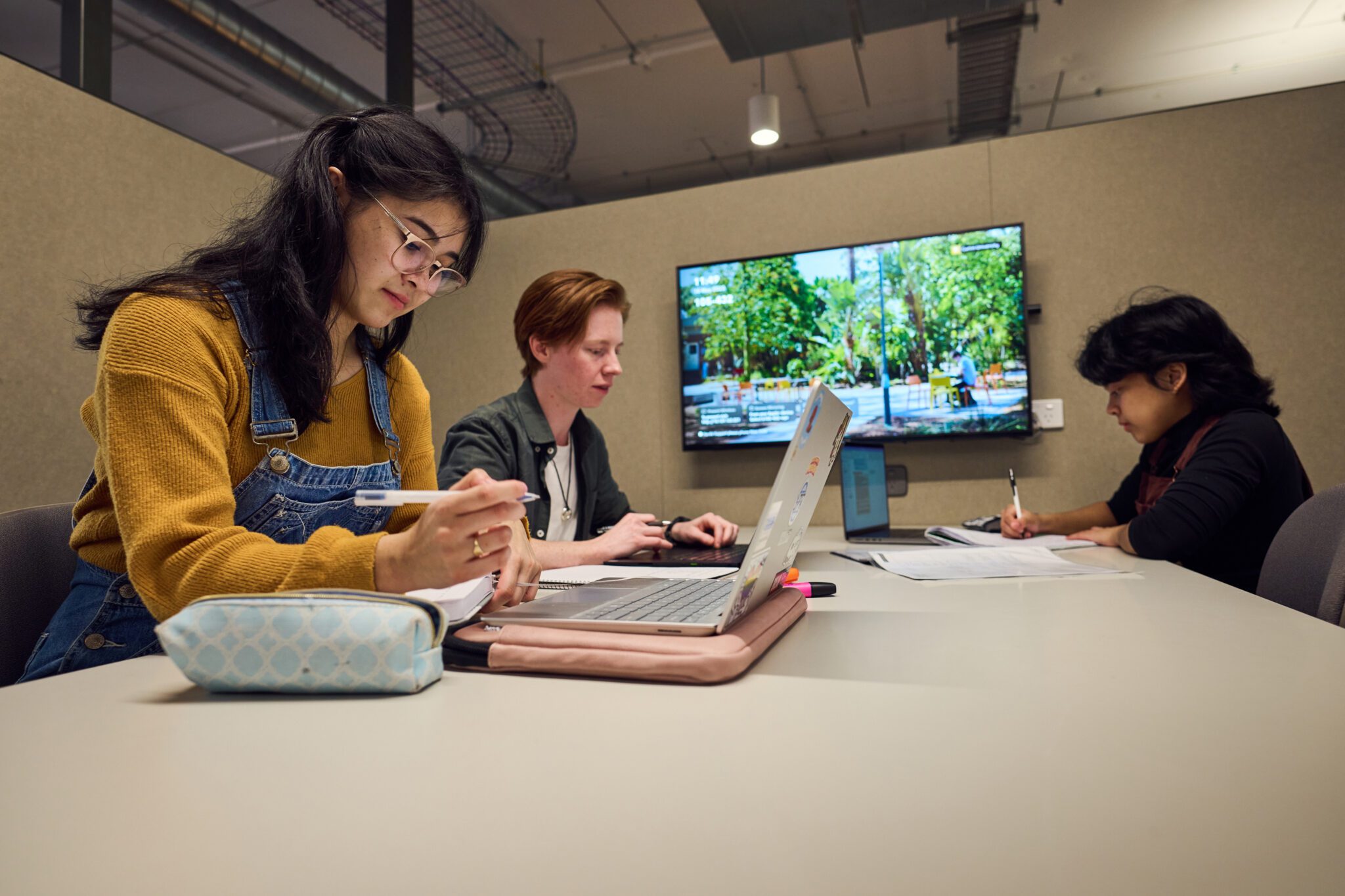 Students sitting together in a study space in TL Robertson Library