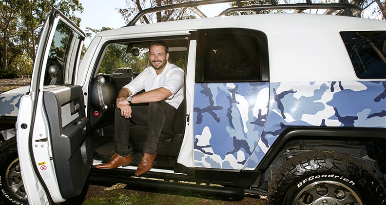 Marc Berryman sitting in vehicle fitted out with Rhinohide.