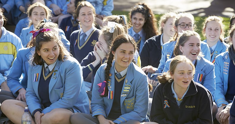 Year 12 girls from St Hilda's look surprised at the arrival of puppies.
