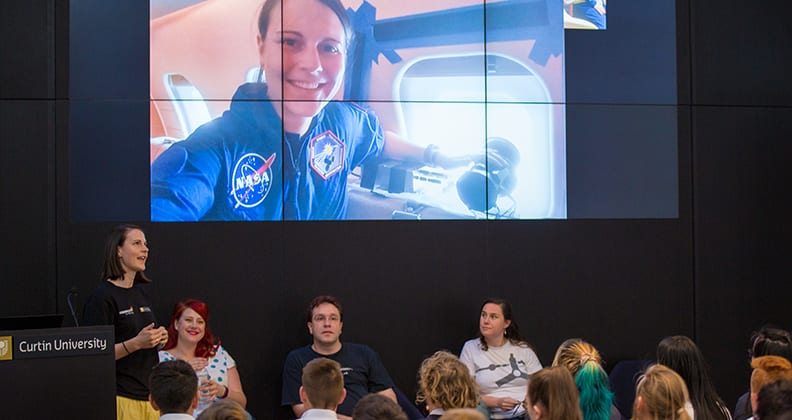 Ellie Sansom talks about her NASA experience with student from Ashdale College at the SSERVI launch. 