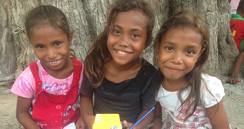 Children from Liquiçá learning about water, health and hygiene through colouring-in books.