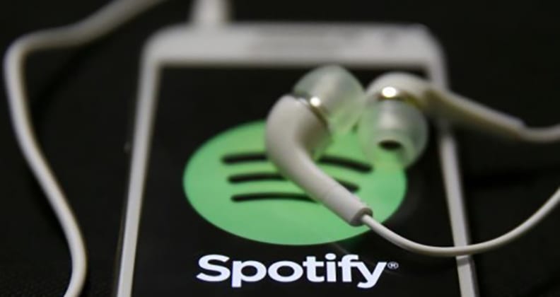 Mobile phone showing Spotify logo.