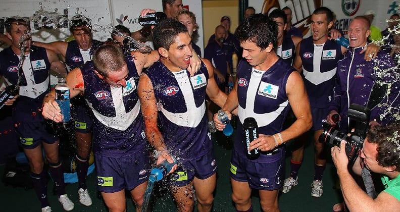 Anthony Morabito celebrates his debut for Fremantle in 2010, flanked by fellow teammates Michael Barlow and Alex Silvagni. 
