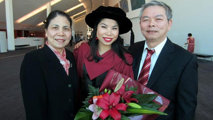 Dr Lam at her PhD graduation with her parents.