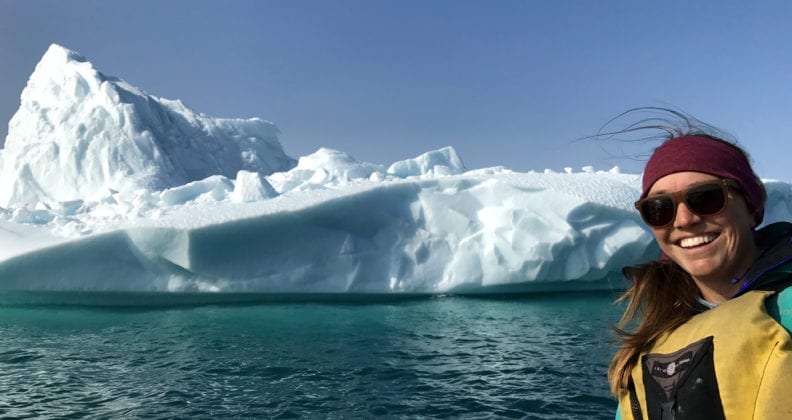 Sarah Crump is dwarfed by an iceberg.