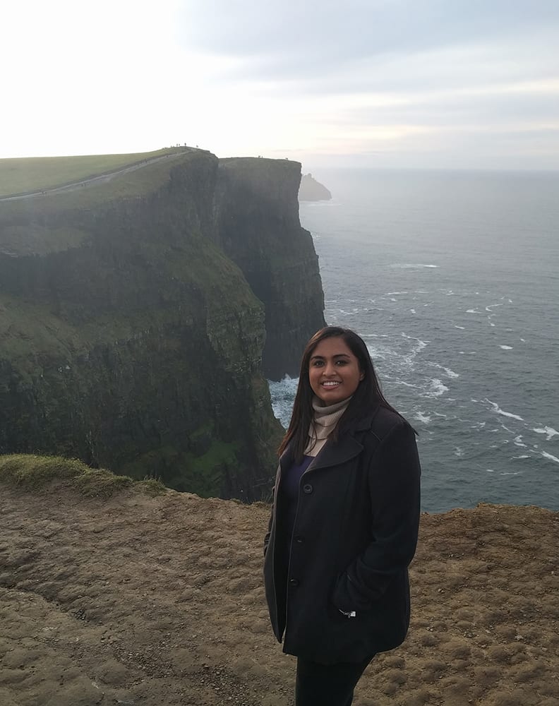 Swati standing above the Cliffs of Moher.