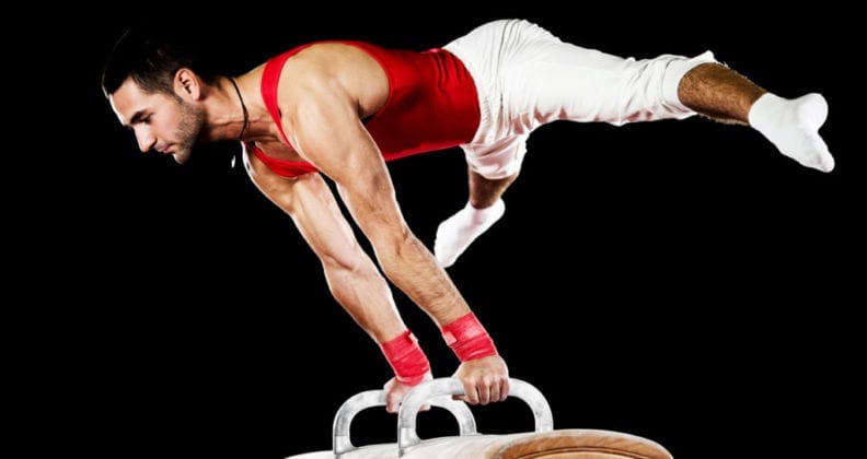 male gymnast on pommel horse
