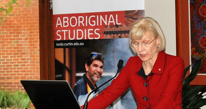 The Vice-Chancellor, Professor Deborah Terry, at a lectern, giving a speech.