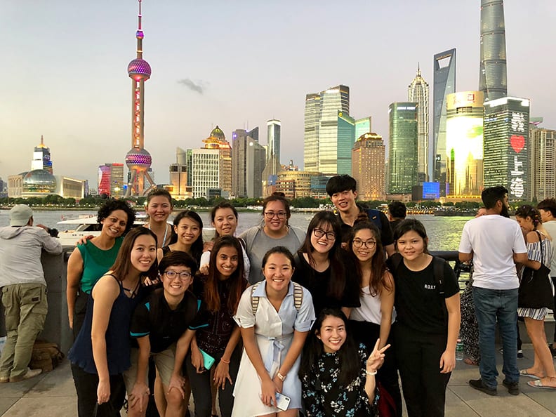 Students in front of the Shanghai skyline.