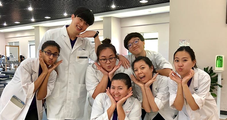 Students posing for a photo with funny faces in the hospital