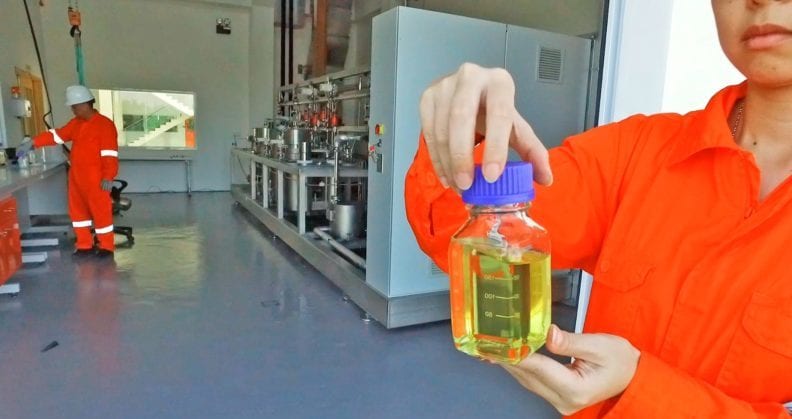 Scientist holding container of frankincense oil.