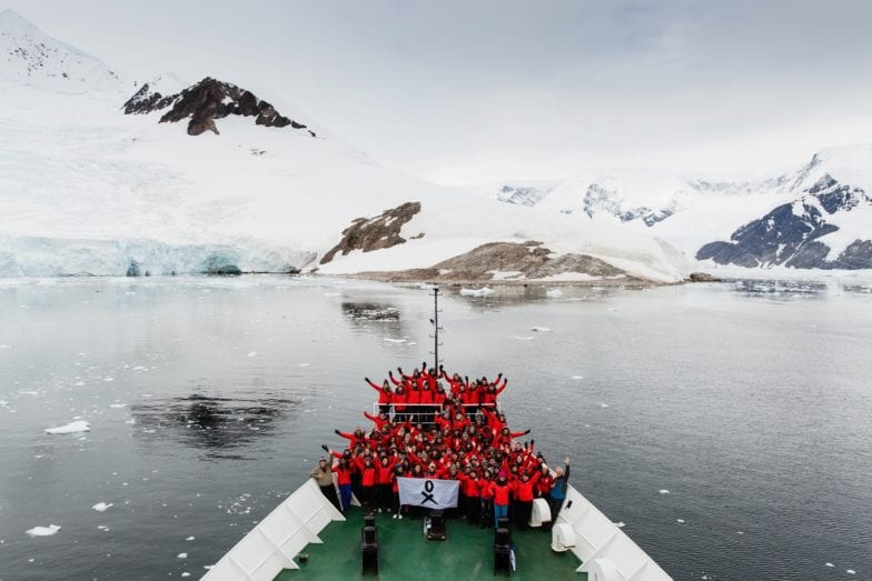 People on ship's bow in Antarctic waters