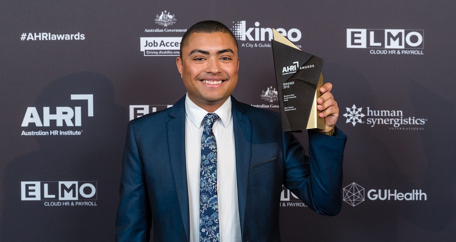 Brandon West holding the Ram Charan Student Award