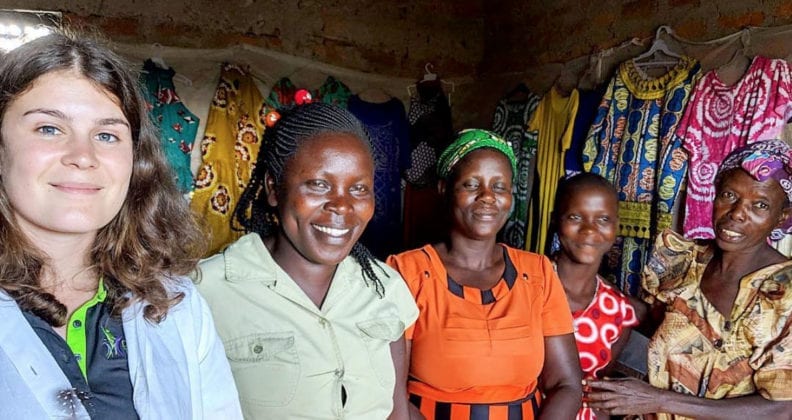 Casey with four Busia women in a clothing shop.