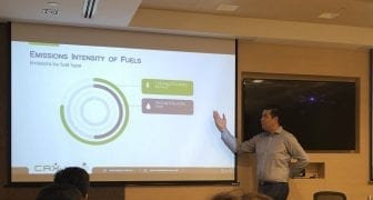 Marc Allen standing in front of a presentation at an emissions reduction workshop