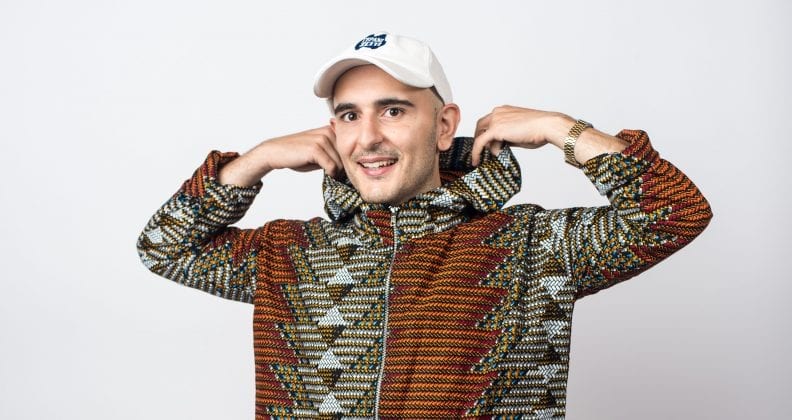 Stacy Gougoulis in a striking hoodie and white cap.