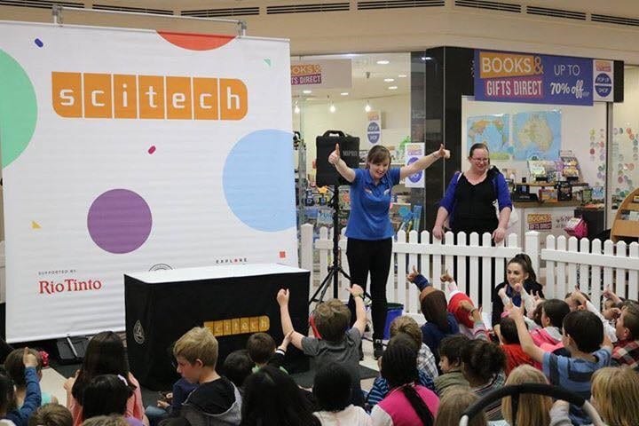 Cassandra giving a science presentation to children at a shopping centre
