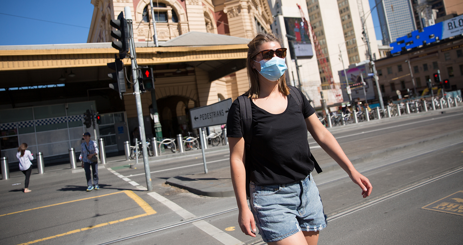 Female wearing mask in Melbourne to protect against COVID-19.