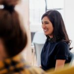 Young woman candidly smiling away at a meeting.