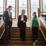 3 Curtin Law students walking down a staircase at the Curtin Law School