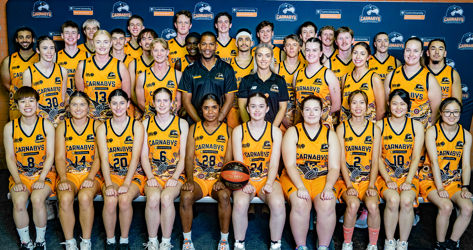 University Basketball League Curtin Carnby Men and Women's Squads with coaches in centre. Group photo orange in uniform.