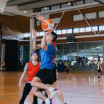 Two students playing basketball
