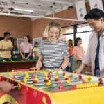 A group of students playing foosball in Curtin's accomodation facility