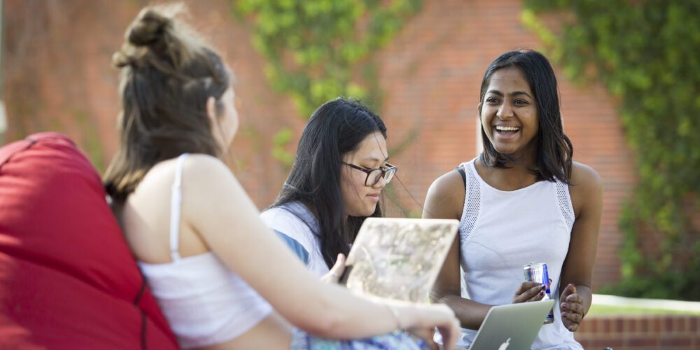 Photo of three female students on bean bags