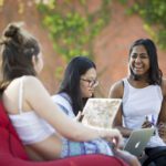 Photo of three female students on bean bags