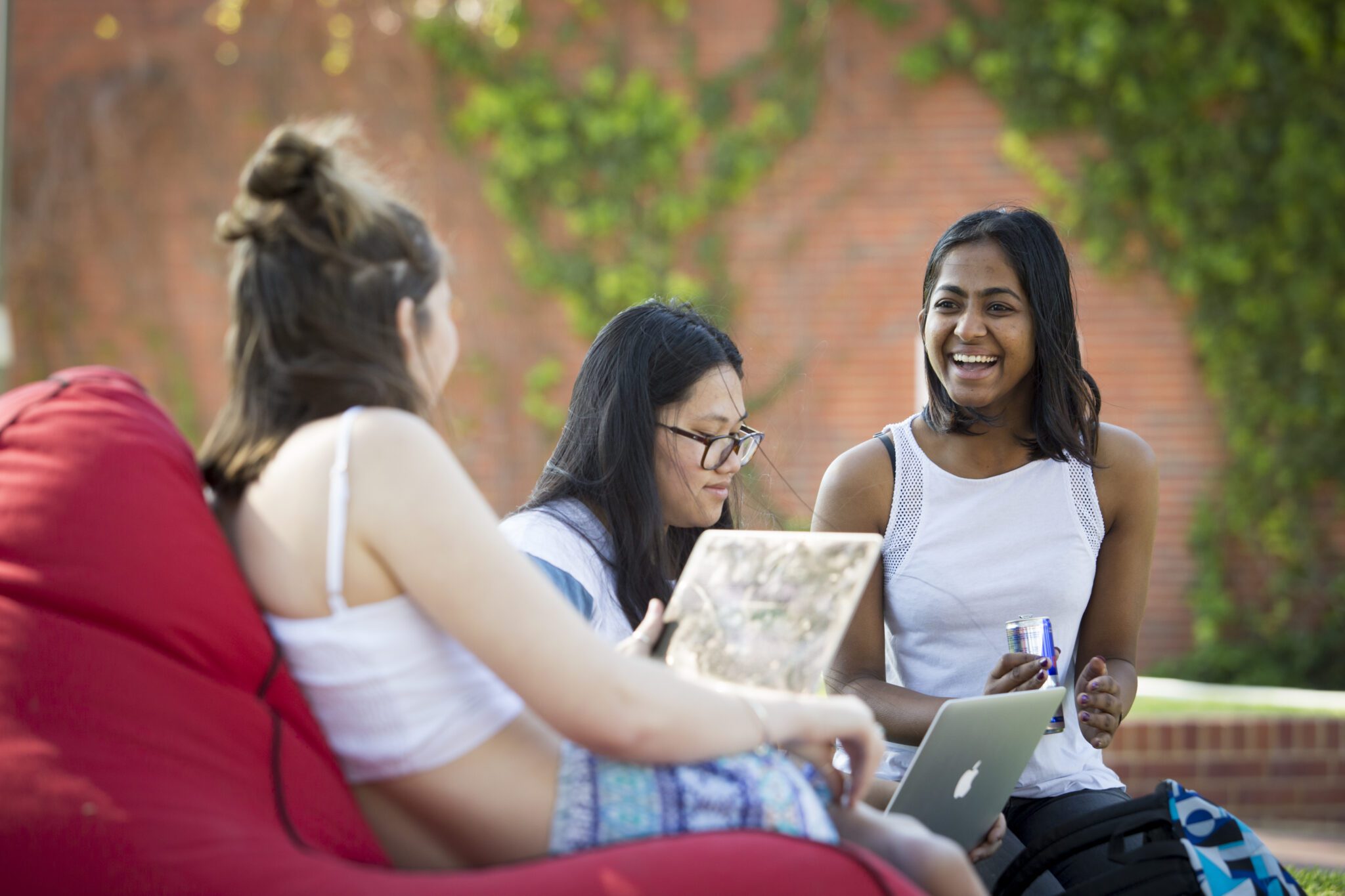 Photo of three female students on bean bags