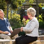 Student talking to AccessAbility staff member outdoors on campus
