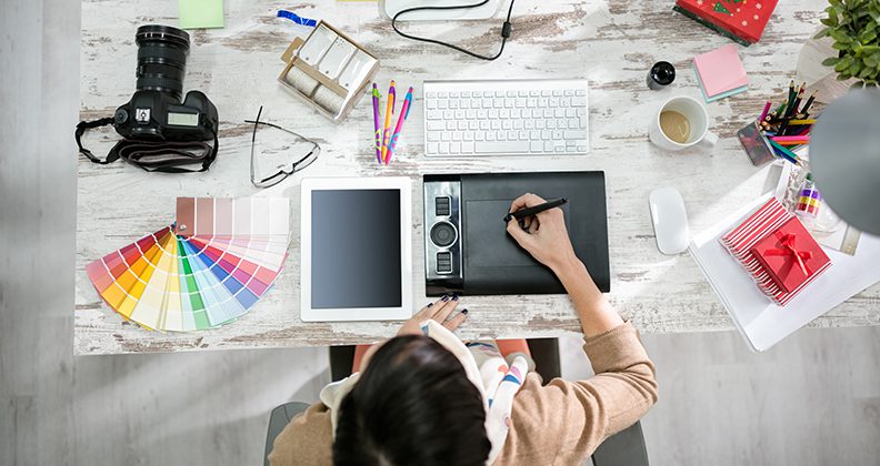 woman designer working on the pen table in office top view
