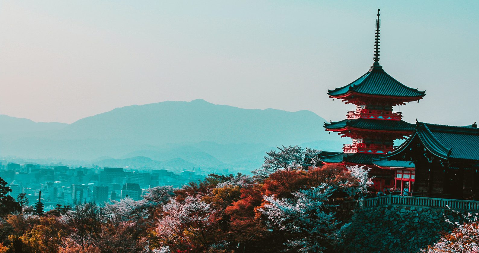Red and Black Temple Surrounded by trees.