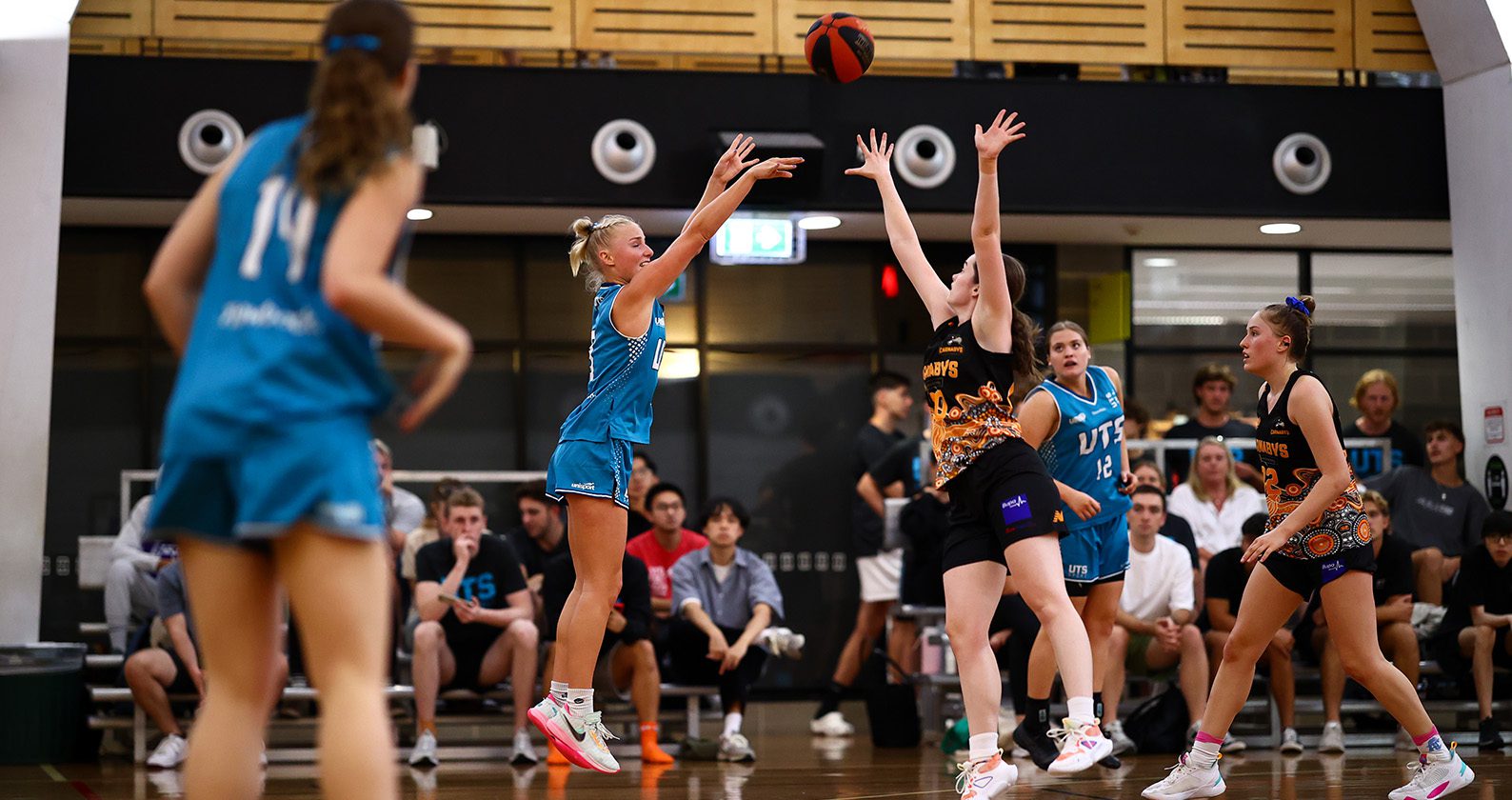 Curtin Carnabys and University of Technology Sydney verse each other in a basketball game