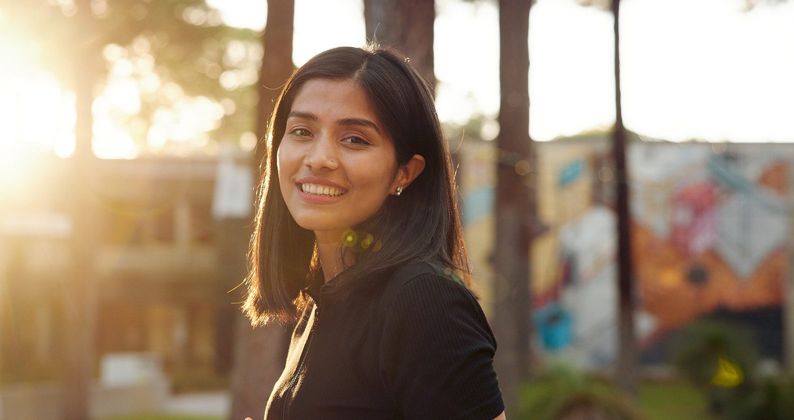 Student on the Curtin Perth campus smiling at the camera.