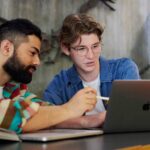 Two students looking at a laptop