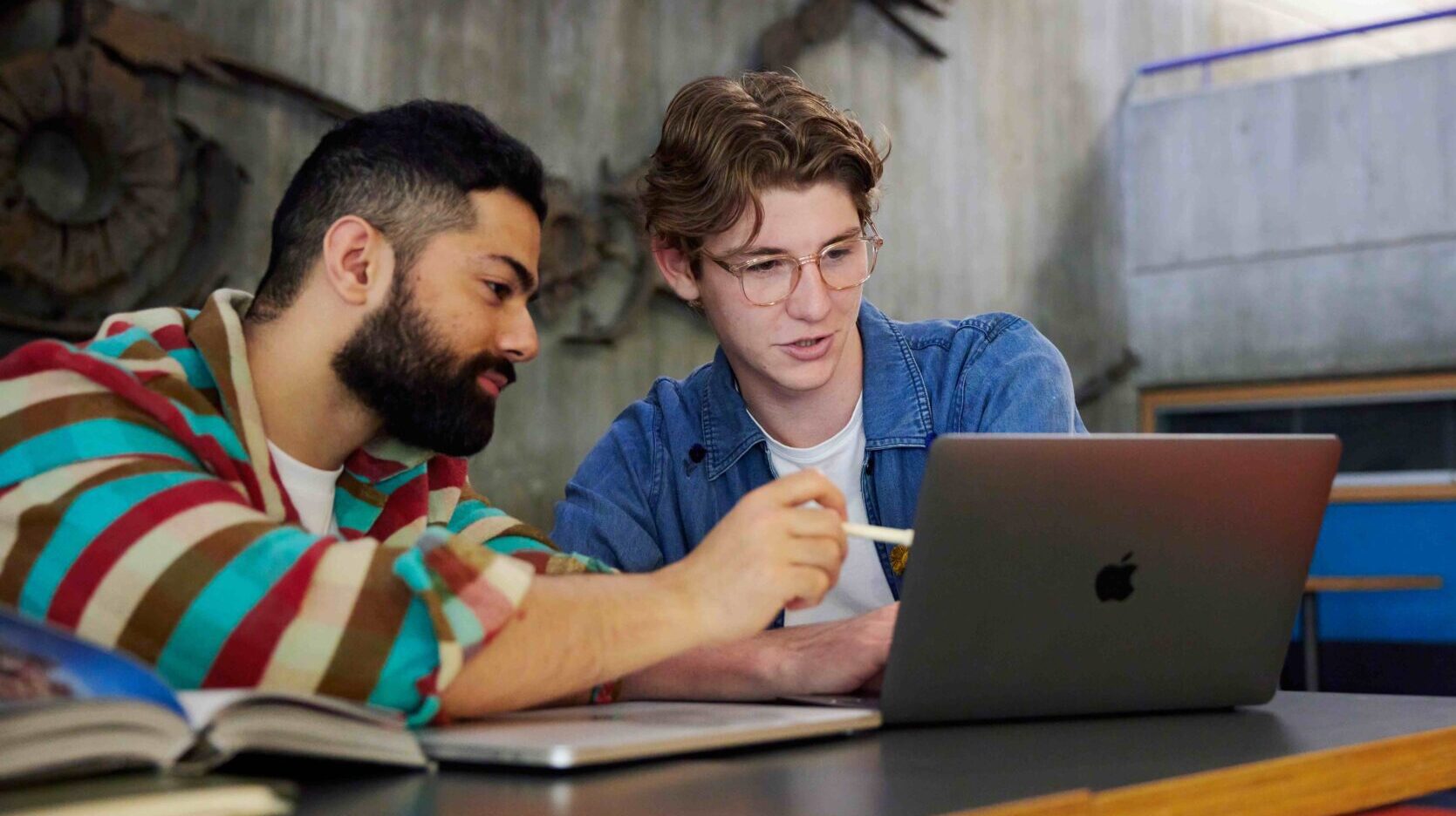 Two students looking at a laptop