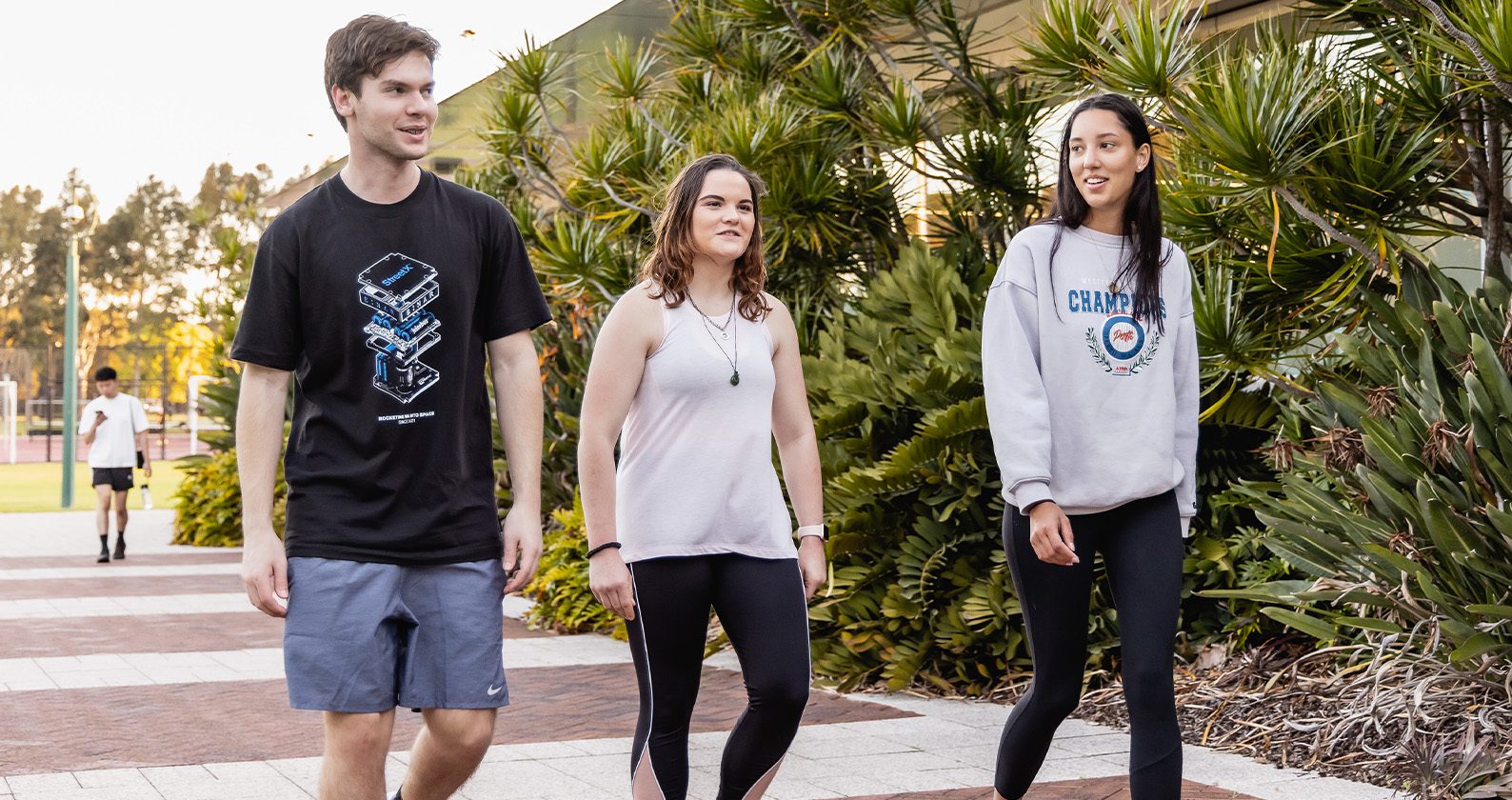 Three students outside the Curtin gym