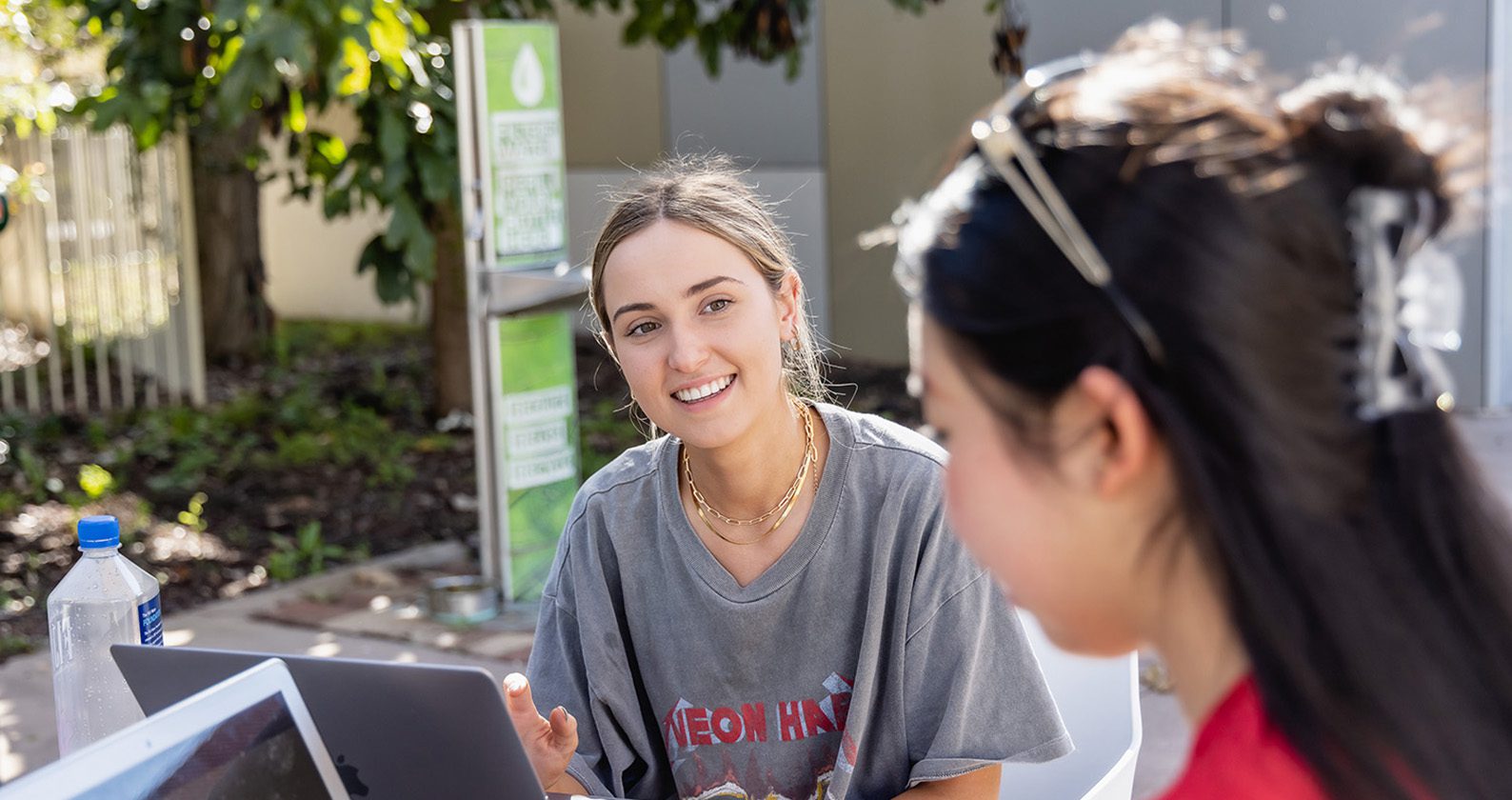 Two females talking together on campus